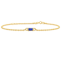 Gold bracelet with a blue gemstone on a white background