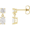 Gold earrings with clear gemstones on a white background