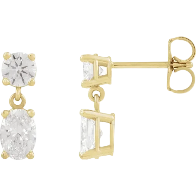 Gold earrings with clear gemstones on a white background