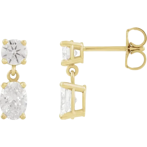 Gold earrings with clear gemstones on a white background